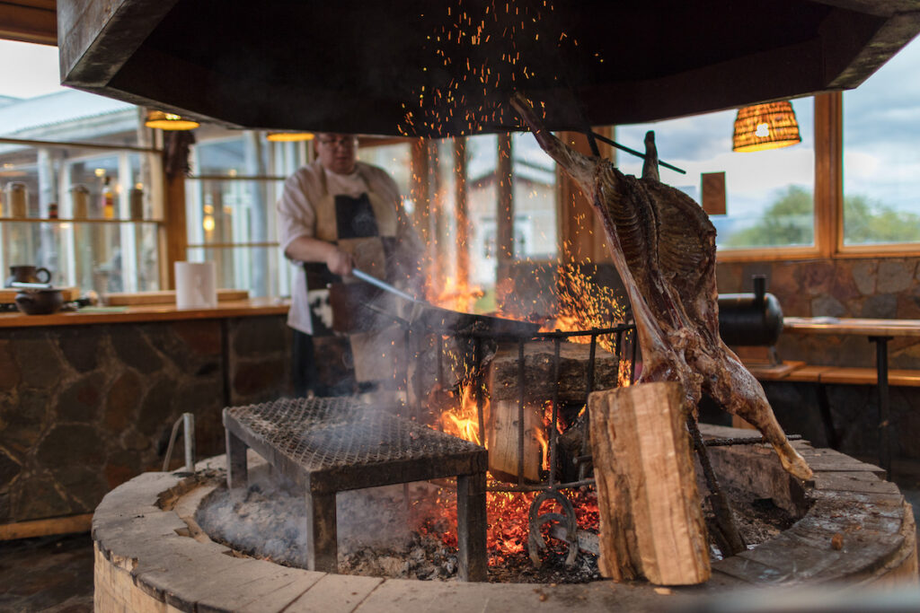 Chef cooking over a fire at Hotel Las Torres