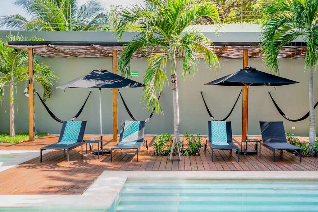Sun loungers and umbrellas by hotel pool