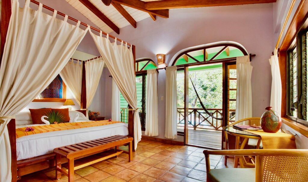King size poster bed at Hamanasi Adventure & Dive Resort