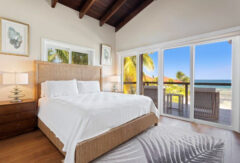 Bedroom and balcony at Ray Caye Island Resort