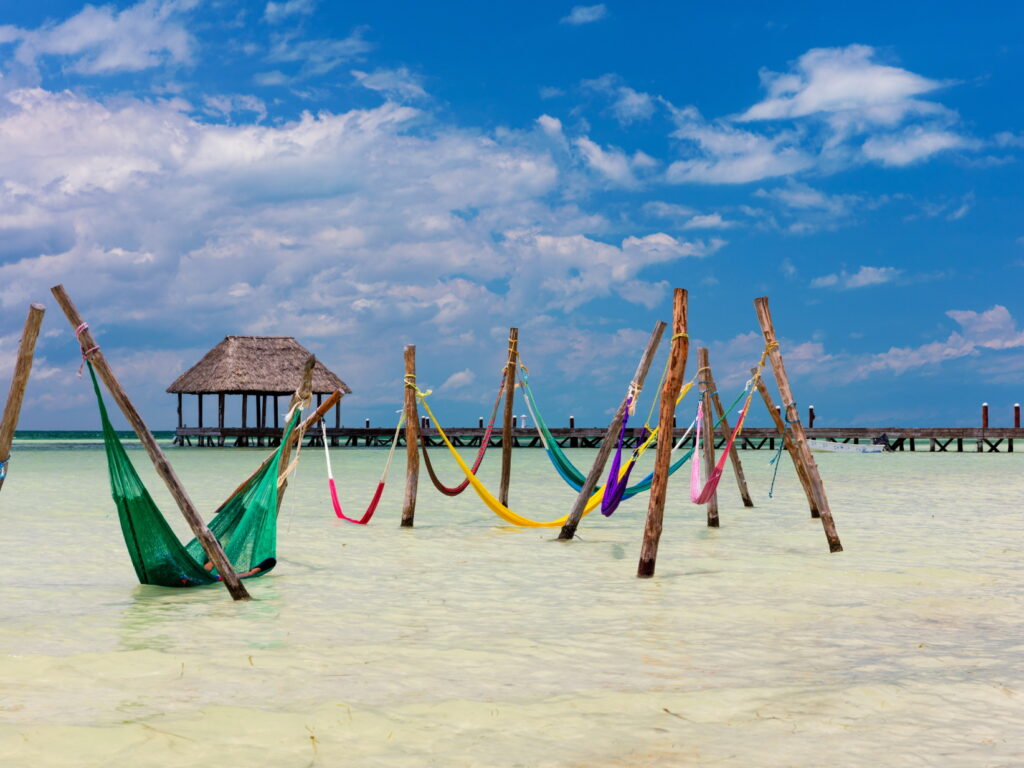 Colourful hammocks in the sea in Mexico
