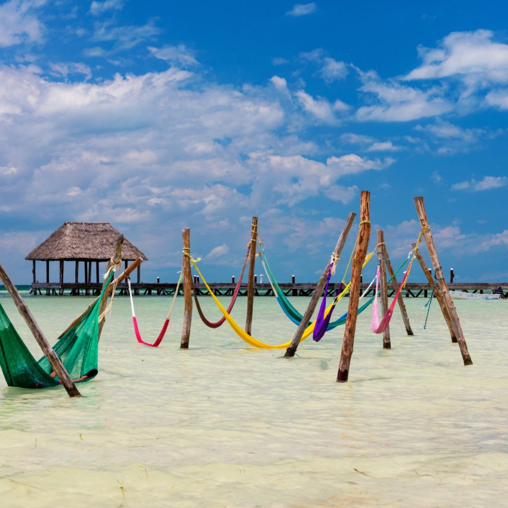 Colourful hammocks in the sea in Mexico