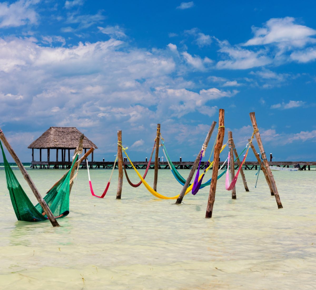 Colourful hammocks in the sea in Mexico