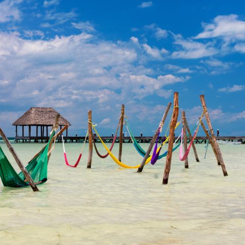 Colourful hammocks in the sea in Mexico