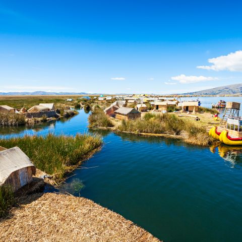 Boats and houses by Lake Titicaca on the Peruvian side