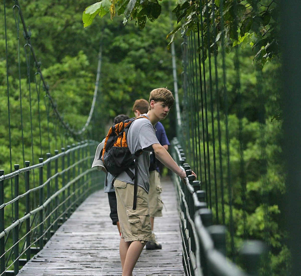 Boys standing on hanging bridges in Costa Rica