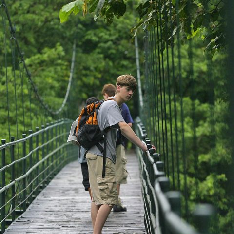 Boys standing on hanging bridges in Costa Rica