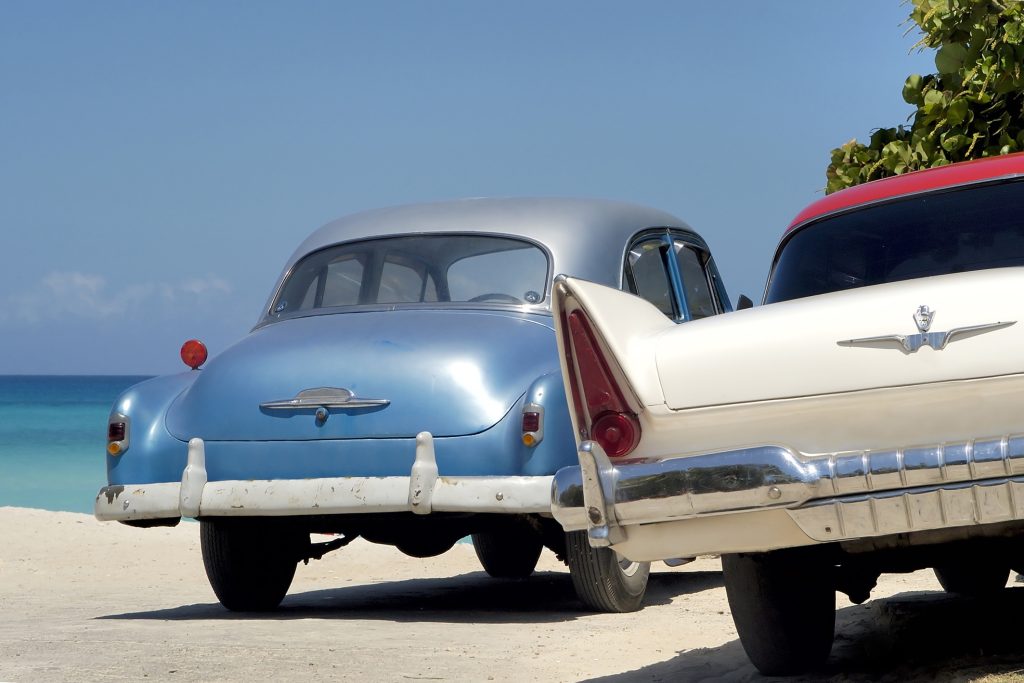 Two old Cuban cars at the beach