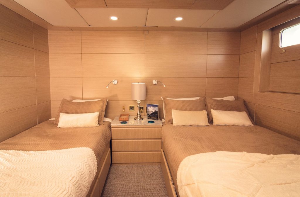 Guest room with two beds on the Passion ship