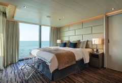 Grand Suite with a double bed and ocean view on the Silver Origin