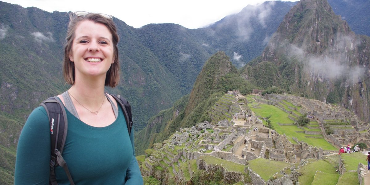 Woman smiling in front of Machu Picchu in Peru
