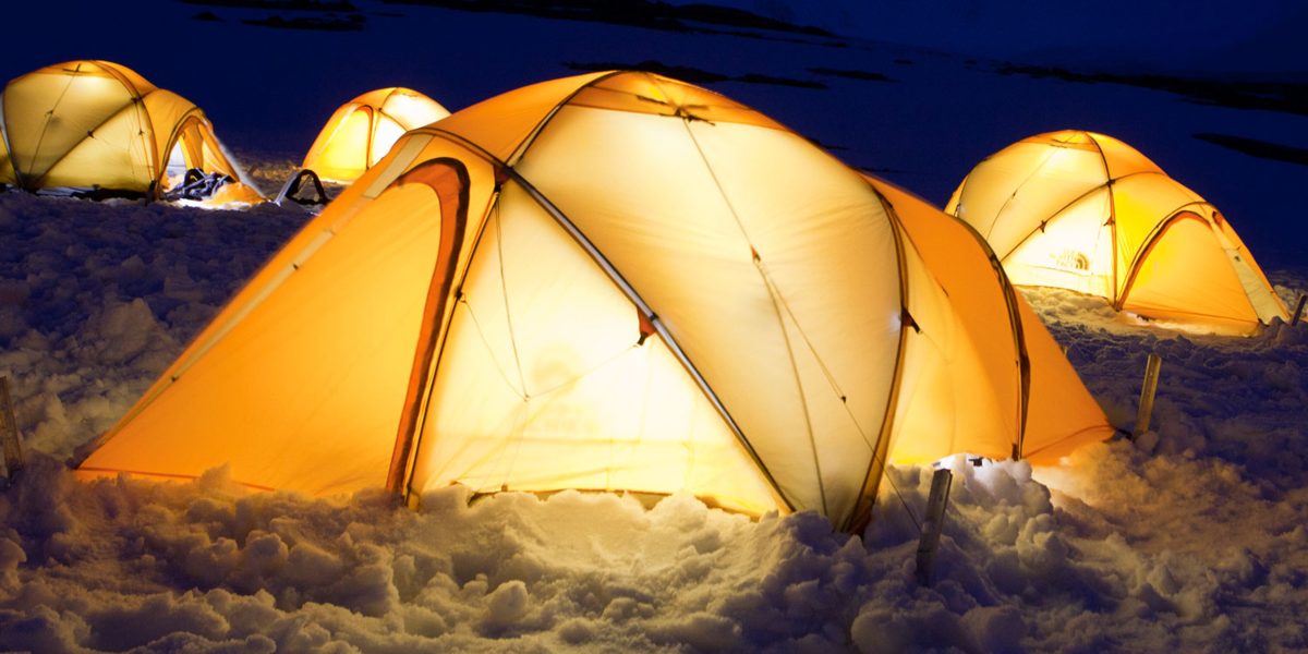 Lit up tents in the snow in Antarctica